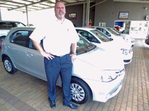 CMH Nissan Highway- Grant standing with a Toyota Etios